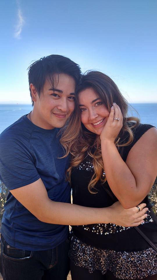 The happily engaged couple, showing off their special engagement ring made by Takayas