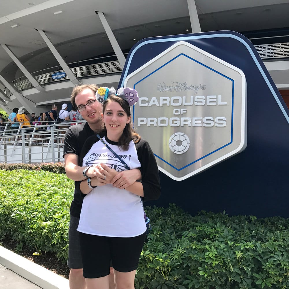 Mike and Ashley, newly engaged, in front of Ashley's favorite ride, the Carousel of Progress