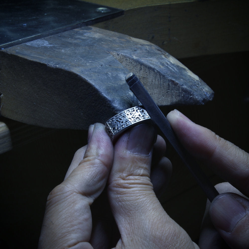 Takayas at the bench, working on the custom Aztec Initials Wedding Ring