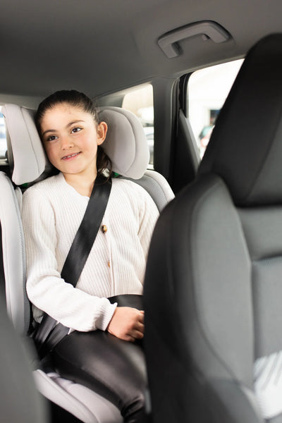 child in high back booster seat