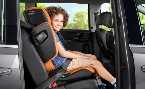 child in high back booster seat