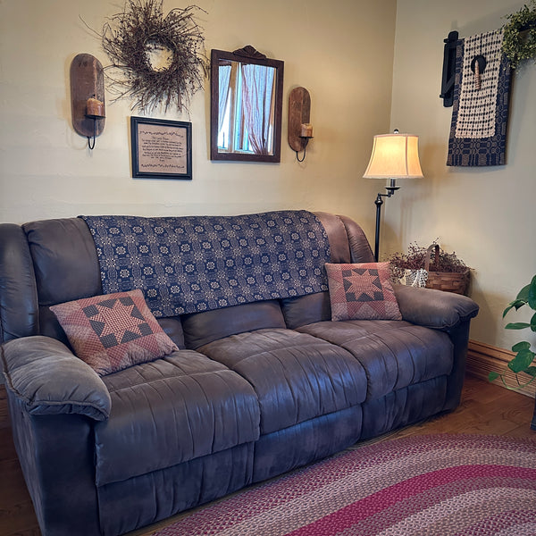 Coverlet shown over the back of a couch