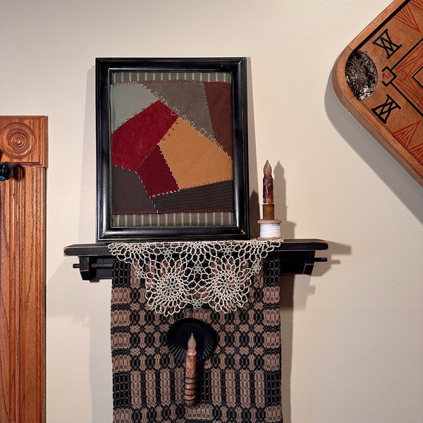 Quilt square framed on the wall