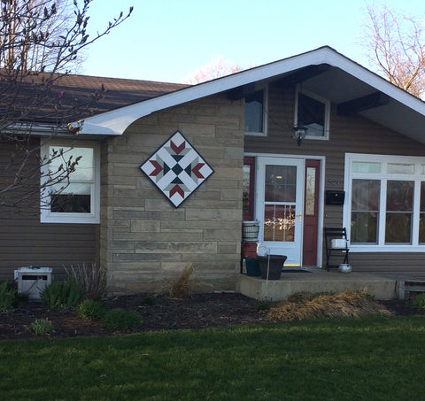 barn quilt on front of house