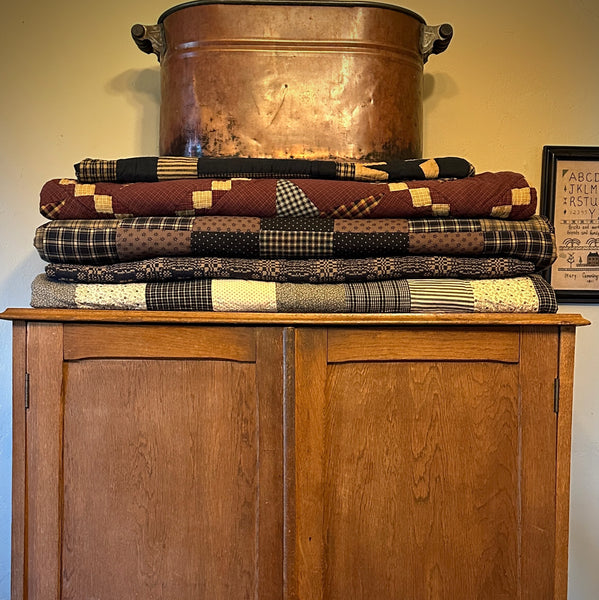 quilts folded on a hutch