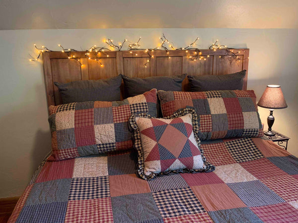 Headboard with lighted garland and Maisie Patch bedding