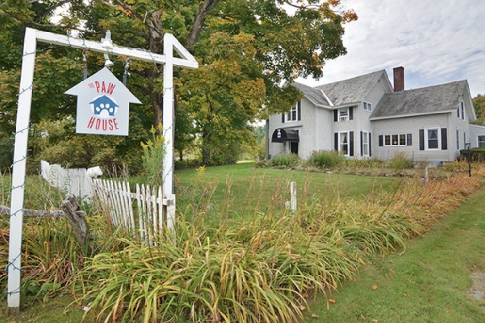 The front yard and entrance to The Paw House Inn dog resort in Vermont.