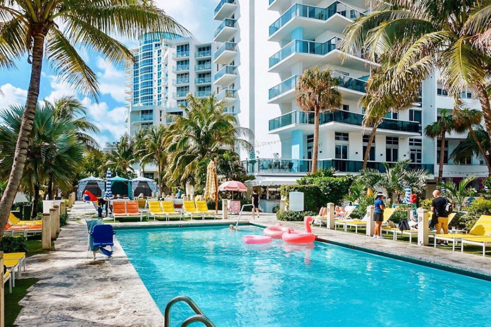  A beautiful pool with poolside seating shadowed by the fabulous Confidante Hotel in Miami.