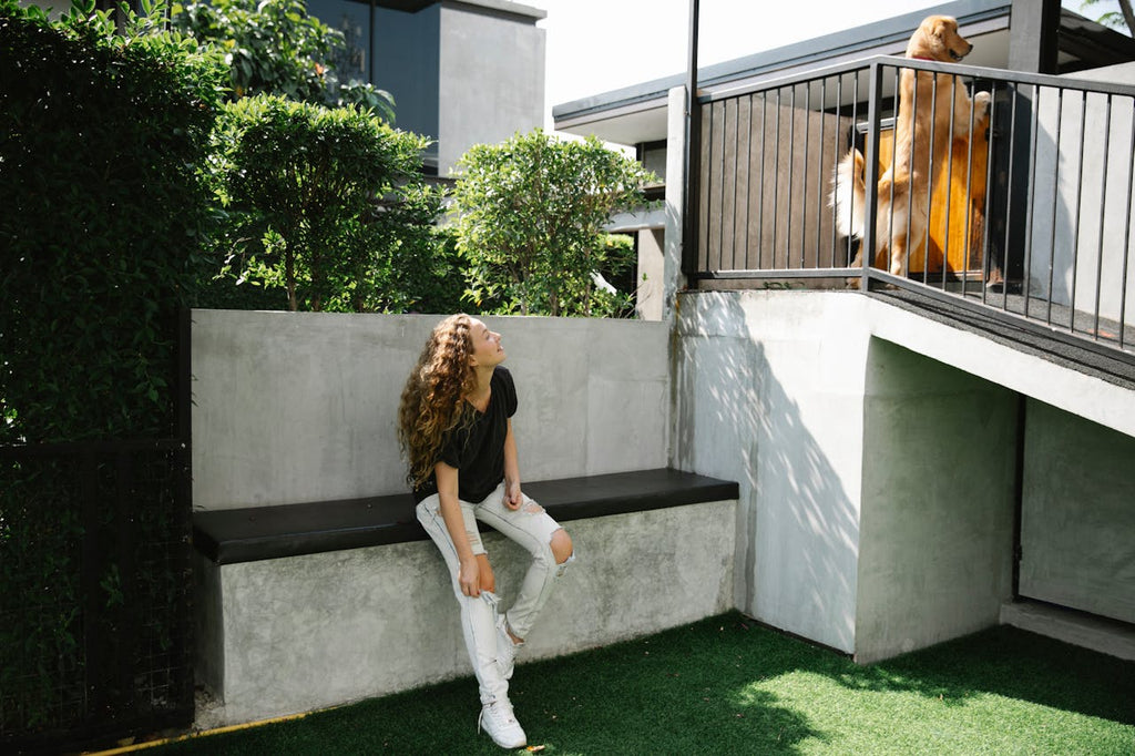 a happy woman watching a dog