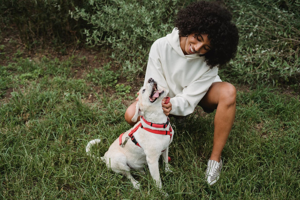 a woman scratching a dogs neck