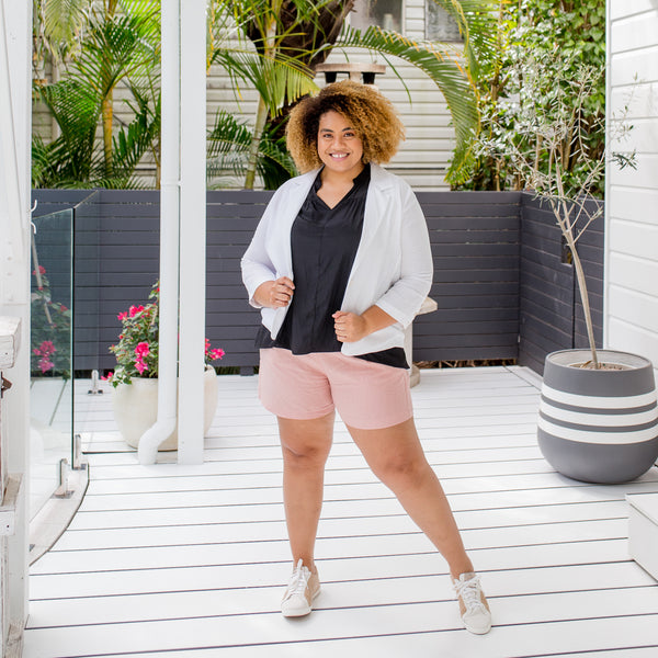 Asinate wearing our Caroline linen blazer in white with our Nadia linen shorts in peach