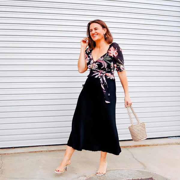 Jasmine from pretty chuffed wearing our deborah satin midi skirt with a floral blouse 