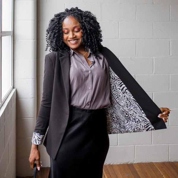 Sonia wearing our Kerryn blazer over our cate technical shirt in sage tucked into our Deborah satin midi skirt. 