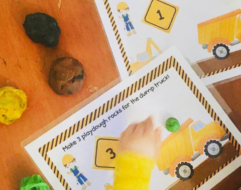 child playing on construction playdough mat