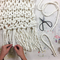 giant chunky woolen yarn blanket made in new zealand using merino sheep wool with xxl knitting needles with added tassels