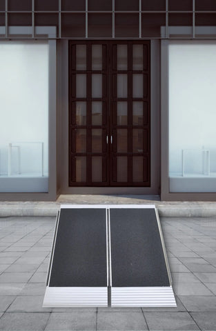 A folding aluminum threshold ramp at a residential front entry