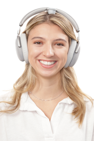 Lady smiling while wearing Vital Neuro headsets