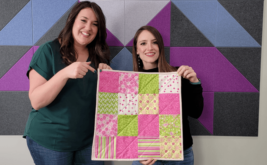 The finished mini quilt featuring Alex and Tricia
