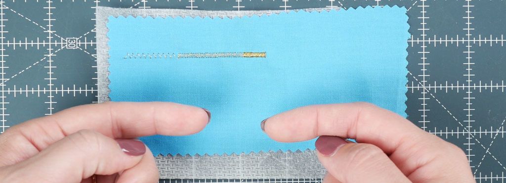 Showing that a satin stitch is a zig zag stitch with decreased stitch length