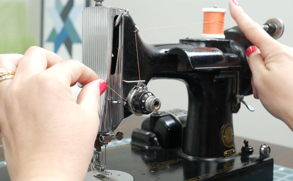 Threading around tension on a singer 221 sewing machine