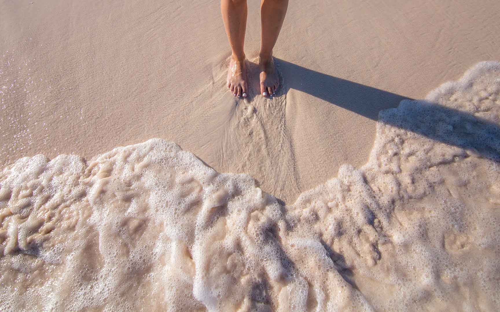 girl with feet in sand