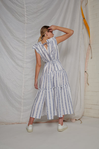 White linen maxi-length, sleeveless dress with blue stripes
