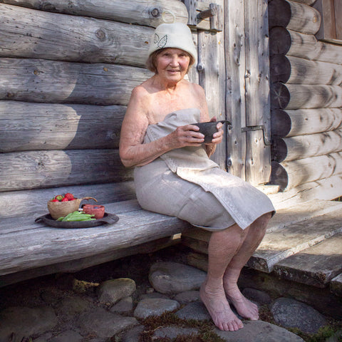 Woman sitting outside sauna