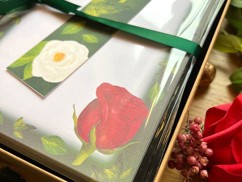 Lovers Lane stationery gift set close up, with bookmark, notepad and card decorated with red roses and ivy