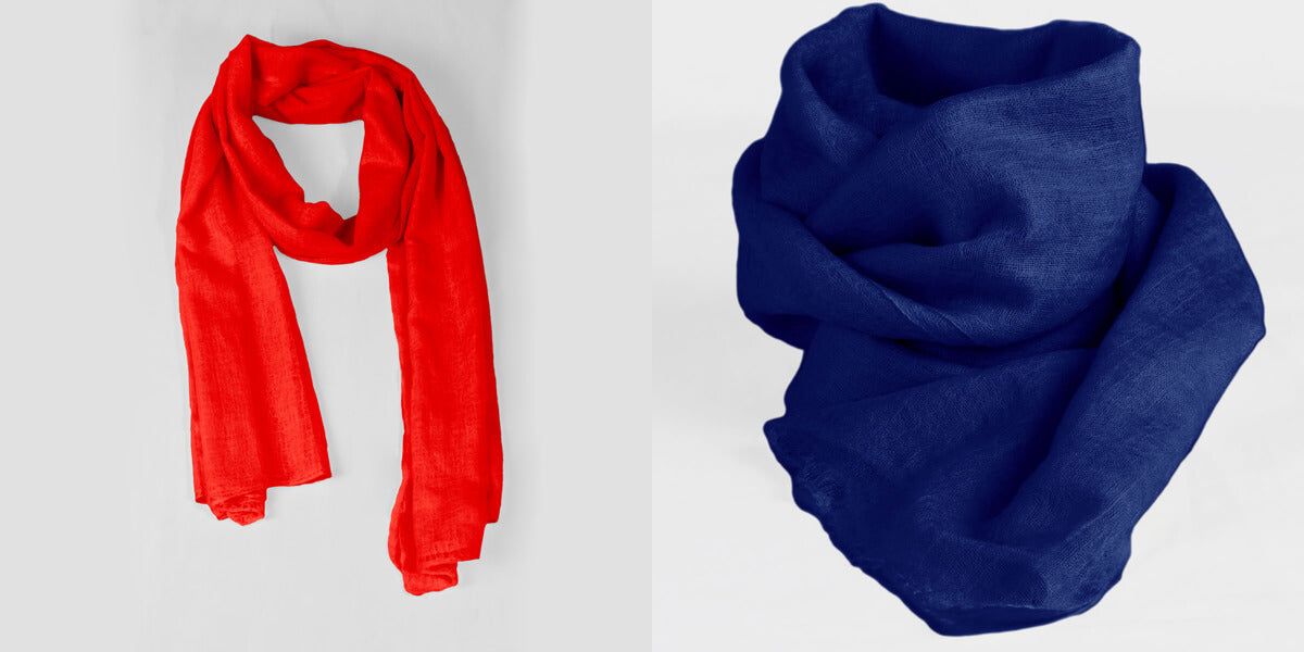 Handwoven 100% pure Red and Persian Blue cashmere shawls side by side to display the unique color combinations they offer.