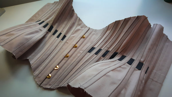 A partly constructed 20 panel corset in mink and black