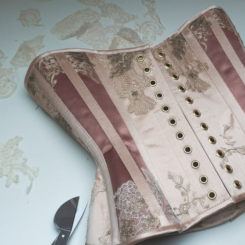Silk satin underbust corset in dusky pink, cream and gold.