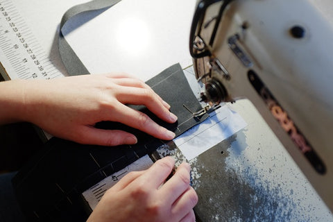 Birds eye view of hands at a sewing machine