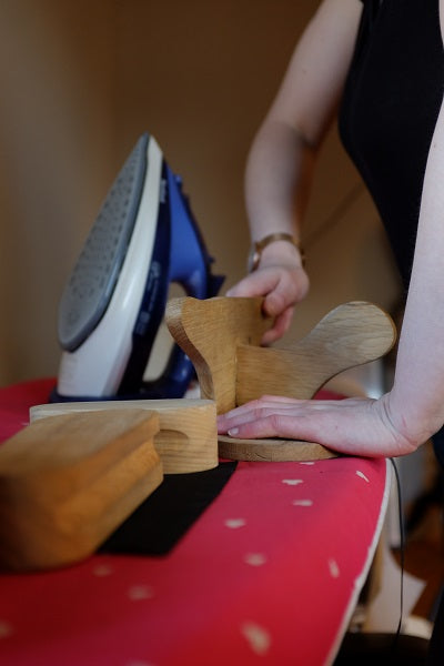 Pressing a corset with a wooden clapper