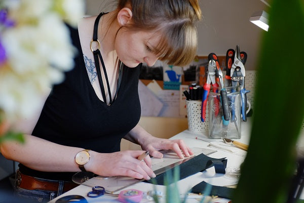 Bethan working on a corset at her workbench