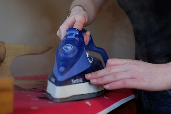 A close up of pressing with an iron