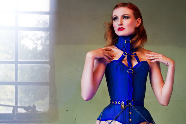 Model wears a cobalt blue silk locking corset with posture collar