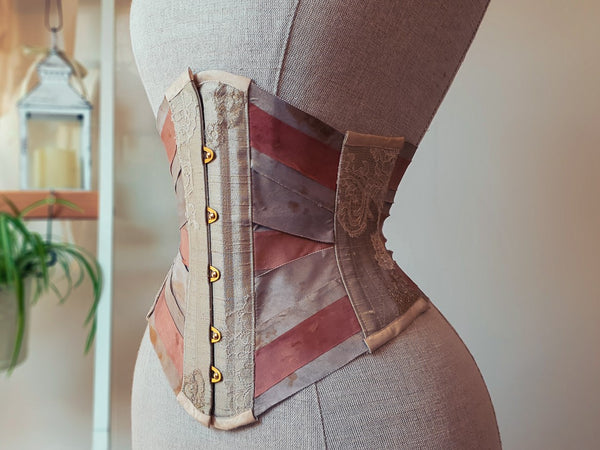 A ribbon corset in pink and beige silk