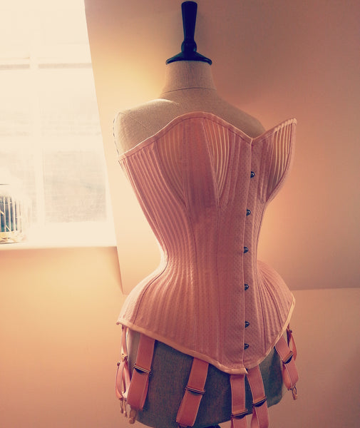Extremely curvy pink cupped overbust corset for a male tightlacer