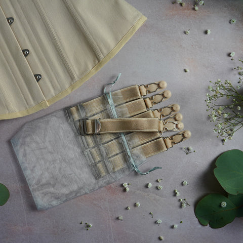 A beige corset surrounded by flowers