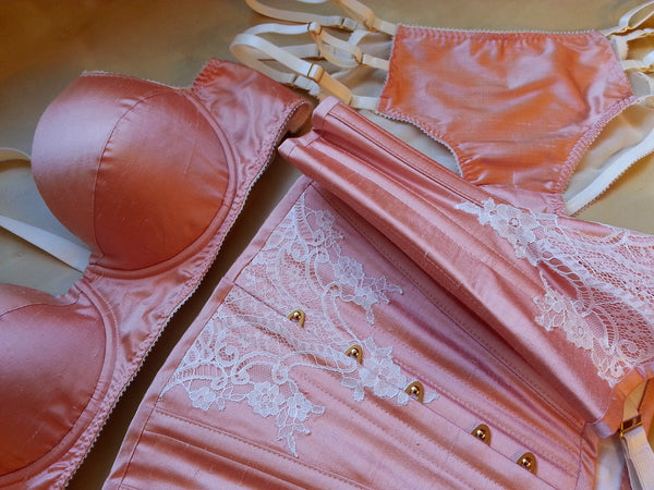 Peach silk bespoke corset with ivory lace applique and matching lingerie set.