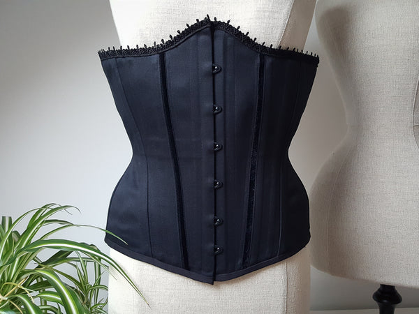 A black male corset with trims