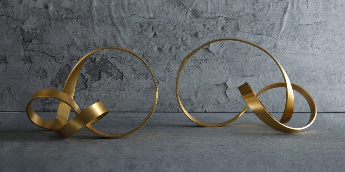 two abstarct decor pieces in gold individually twisted
