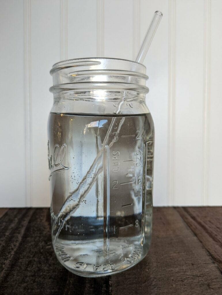 mason-jar-lifestyle-hydration-water-blog-post-water-in-quart-jar-with-glass-straw-showing-measurement-markings