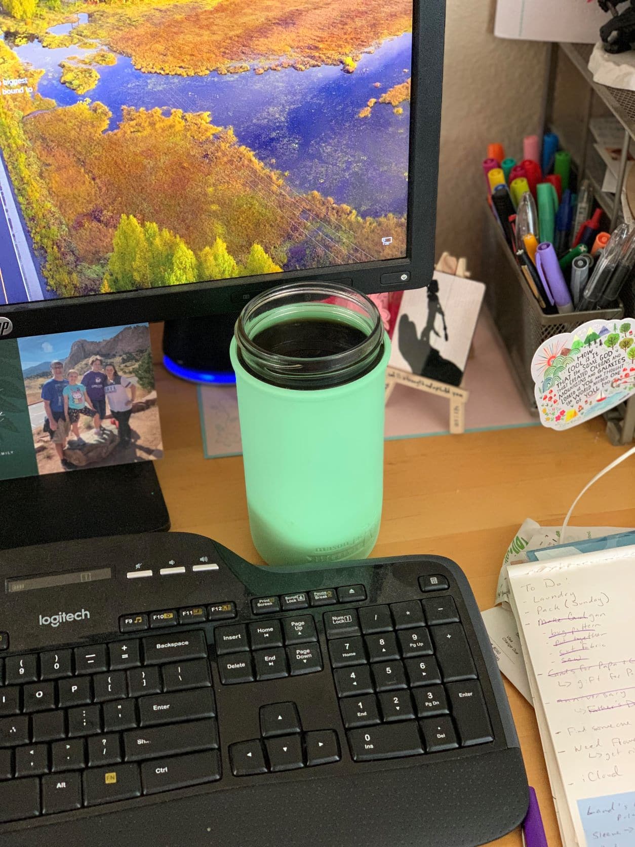 mason-jar-lifestyle-pint-and-a-half-silicone-sleeve-in-mint-with-black-coffee-at-desk-for-working-from-home