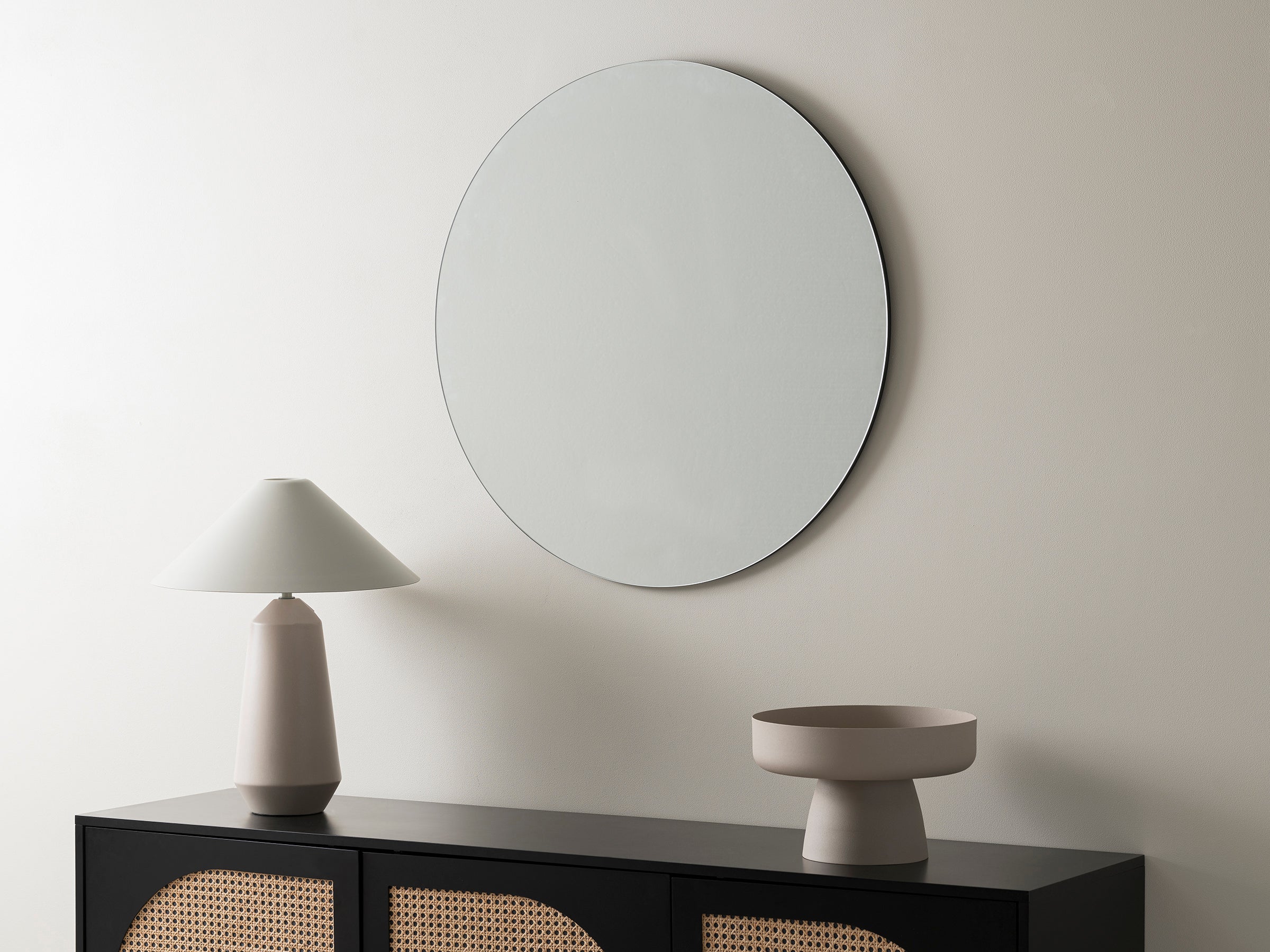 a frameless round wall mirror