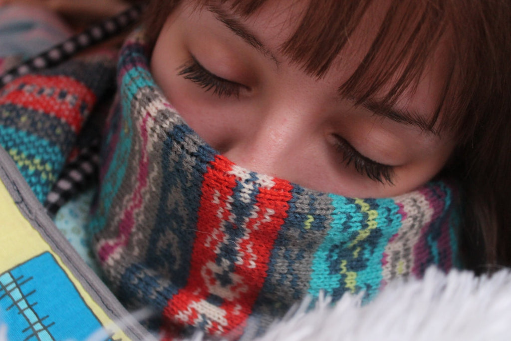 person covering mouth with scarf