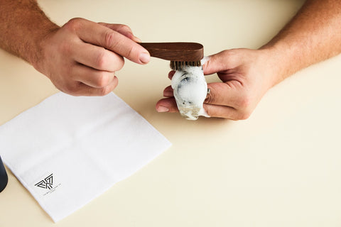 Man cleaning a stainless steel watch with The Watch Care Kit