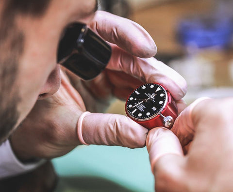Watchmaker servicing a watch