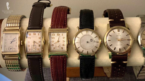 Different vintage watches on a watch stand