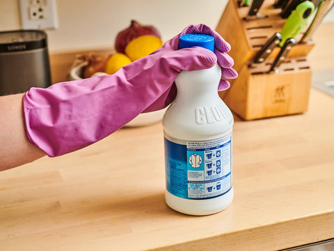 A person using bleach for cleaning